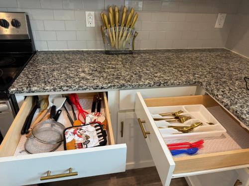 a kitchen counter with a drawer full of utensils at Modern Stay in Killeen in Killeen