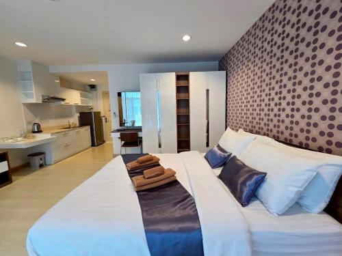 Ένα ή περισσότερα κρεβάτια σε δωμάτιο στο The Beach Bangsaen Condo 327-23