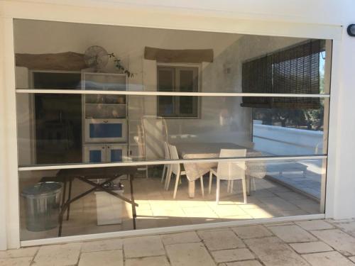 a view of a kitchen through a sliding glass door at Villa Colle in Ostuni