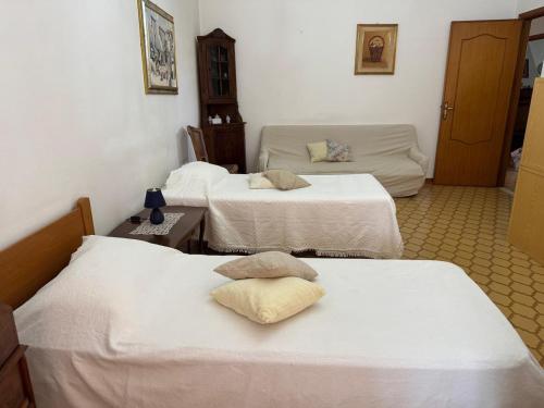 a room with three beds and a couch at Home Green in Mògoro