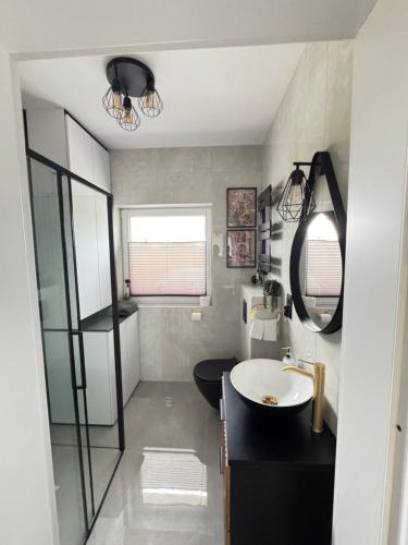 a bathroom with a sink and a mirror at Chill&Love Apartament 