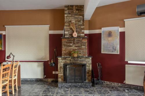 a brick fireplace in a room with red walls at The Family House in Larnaca