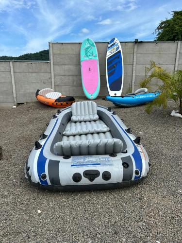 a boat and surfboards are sitting on the ground at Eco Glamping Verde, Bahia Gigante in Puntarenas