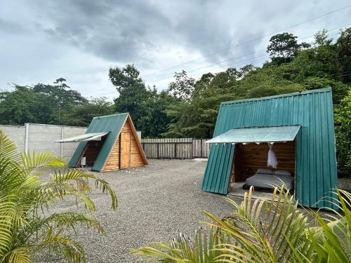 two small tents in a yard with a fence at Eco Glamping Verde, Bahia Gigante in Puntarenas