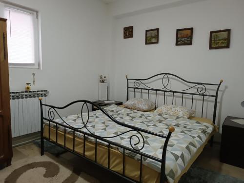 a bedroom with a black bed with pillows on it at Mountain Relax Vlašić in Vlasic