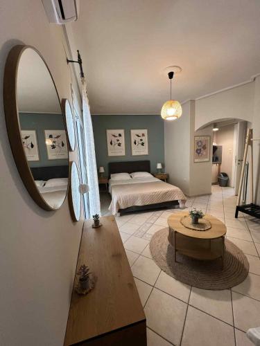 a bedroom with a bed and a large mirror at central studio very close to the port of Volos in Volos