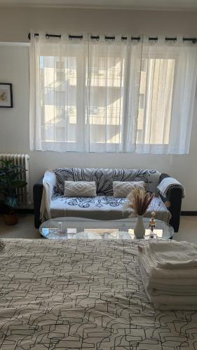 un salon avec un canapé et une table dans l'établissement Nice Séjour Detente Studio Lumineux Balcon Cuisine Equipée Wifi, à Nice