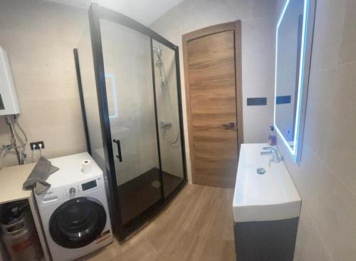 a bathroom with a shower and a washing machine at Brisa Marina in Cullera