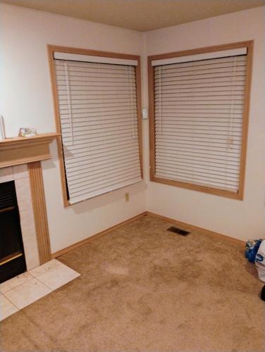 a living room with two windows with blinds on them at Cedar River One Bedroom In A 4 Bedroom House in Renton