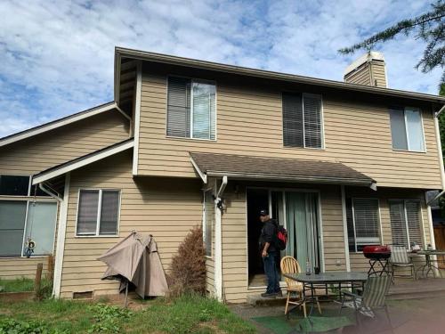 a man standing in the doorway of a house at Cedar River One Bedroom In A 4 Bedroom House in Renton