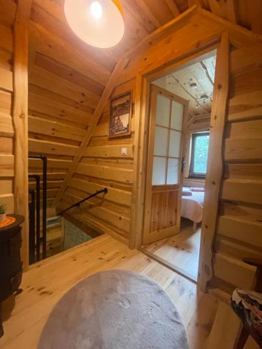 a log cabin with a staircase in a room at Wilkaski zakątek in Giżycko