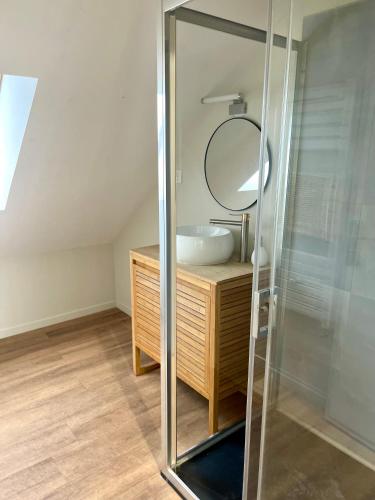 a bathroom with a sink and a mirror at Le Parisien in Le Mans