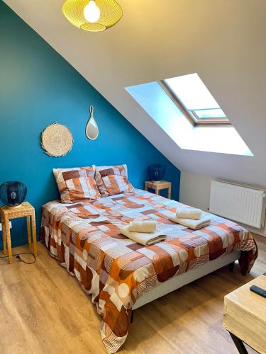 a bedroom with a bed with a skylight at Le Parisien in Le Mans