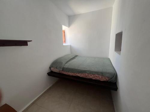 a small bedroom with a bed in a white room at Gennadi Sunrise in Gennadi
