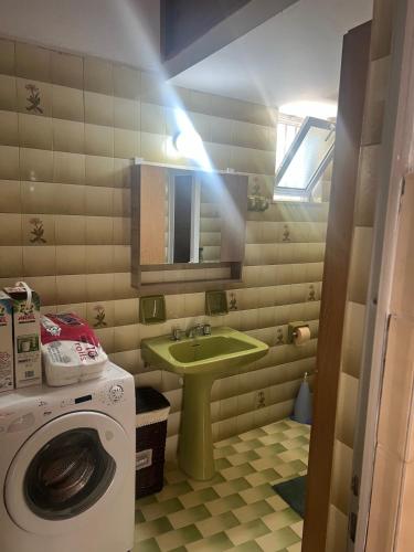 a bathroom with a sink and a washing machine at Gennadi Sunrise in Gennadi