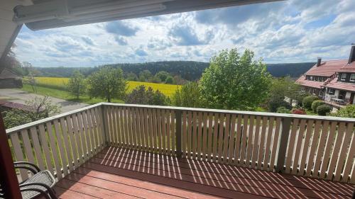 a balcony with a view of a field of flowers at Ferienwohnung Zimmerei Schwarzwald mit toller Aussicht in Bad Teinach-Zavelstein