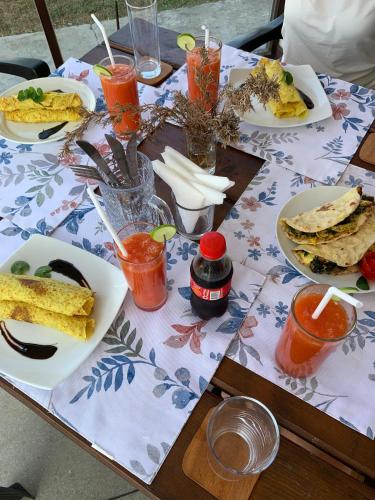 a wooden table with plates of food on it at The Aurelia in Gampola