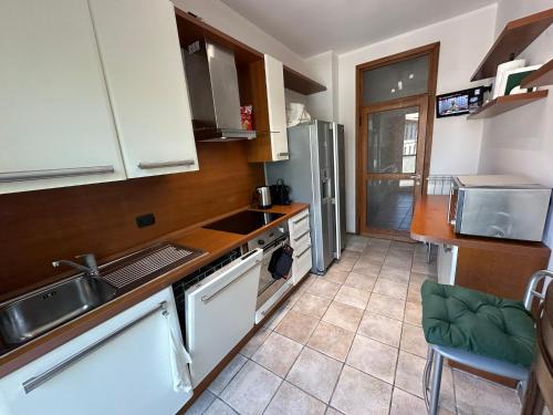 a kitchen with a sink and a stove top oven at Casa Dante - Central apartment in Lecco in Lecco