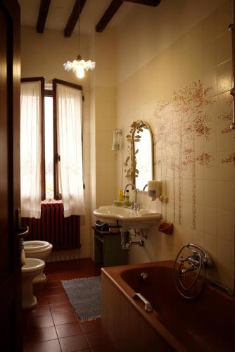 a bathroom with a tub and a sink and a toilet at La Lepre Bianca in Cento