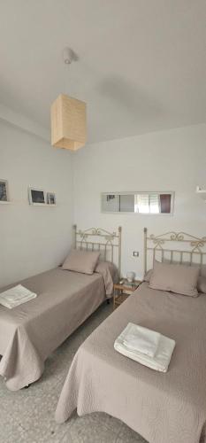 a bedroom with two beds and a ceiling at Fantástico duplex en el centro de Osuna in Osuna