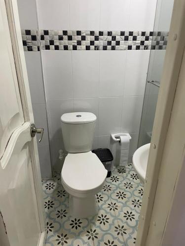 a small bathroom with a toilet and a sink at Aparta hotel Montecristo Suites in Quimbaya