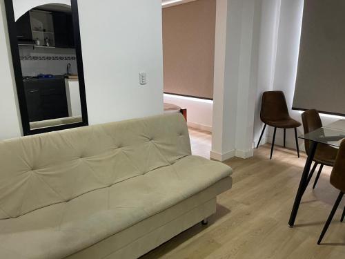 a living room with a couch and a table at Aparta hotel Montecristo Suites in Quimbaya