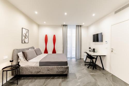a bedroom with a bed and a desk in it at Marenda - B&B in Bari