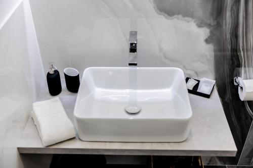 a bathroom with a white sink on a counter at Marenda - B&B in Bari