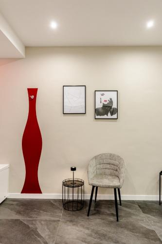 a room with a chair and two vases on the wall at Marenda - B&B in Bari