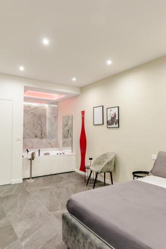 a bedroom with a bed and a red vase on the wall at Marenda - B&B in Bari