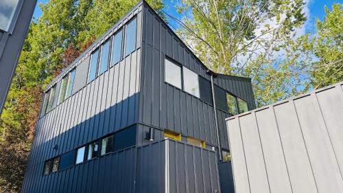 an office building with a black and white facade at Brand New Designer House 15min to downtown in Seattle