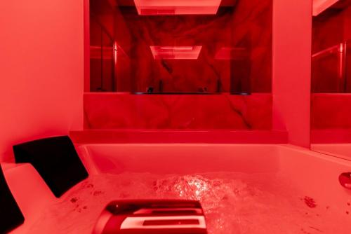 a red bathroom with a red tub with a sink at Marenda - B&B in Bari
