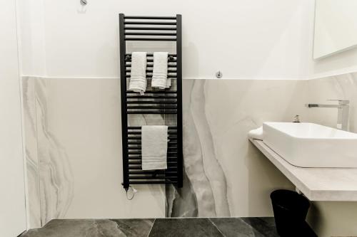 a bathroom with a black towel rack next to a sink at Marenda - B&B in Bari