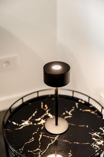 a black and gold table with a black top at Marenda - B&B in Bari