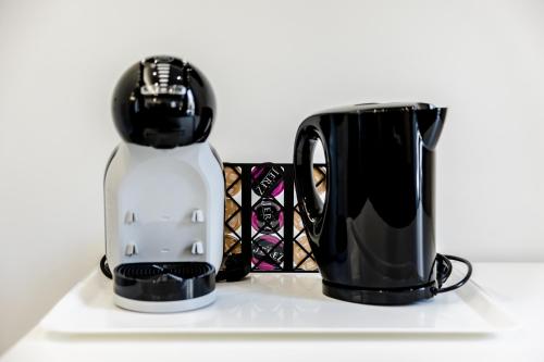 affeepot and a coffee pot on a white tray at Marenda - B&B in Bari