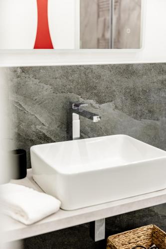 a white sink on a shelf in a bathroom at Marenda - B&B in Bari