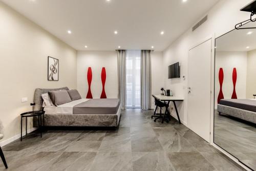a bedroom with a bed and a desk in it at Marenda - B&B in Bari