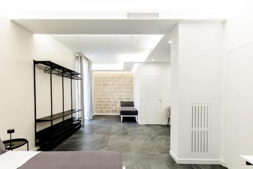 a bedroom with a bed and a chair in a room at Marenda - B&B in Bari