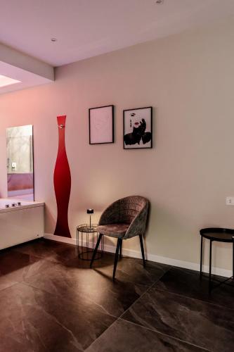 a room with a chair and two vases on the wall at Marenda - B&B in Bari