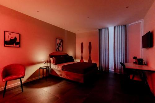 a red bedroom with a bed and a red chair at Marenda - B&B in Bari