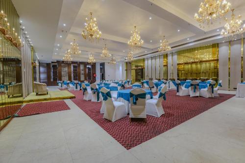 a banquet hall with blue and white tables and chairs at Aceotel Select Aria, Bhopal -A Luxury Boutique Hotel in Bhopal