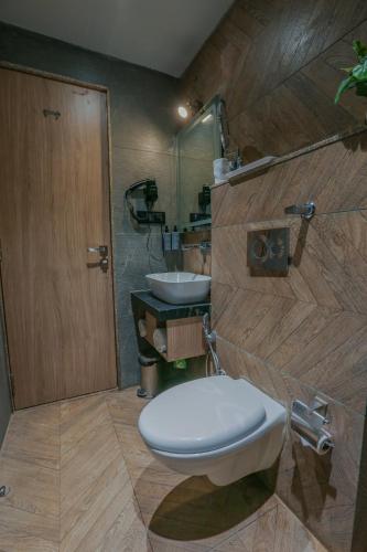 a bathroom with a toilet and a sink at Aceotel Select Aria, Bhopal -A Luxury Boutique Hotel in Bhopal