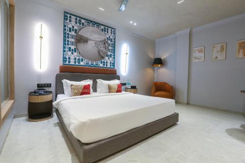a bedroom with a large white bed in a room at Aceotel Select Aria, Bhopal -A Luxury Boutique Hotel in Bhopal
