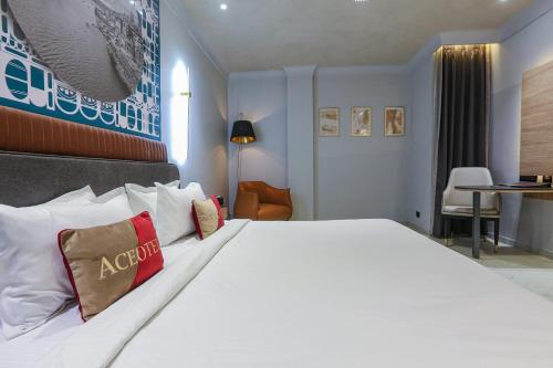 a hotel room with a large white bed with pillows at Aceotel Select Aria, Bhopal -A Luxury Boutique Hotel in Bhopal