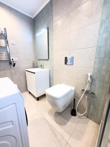a bathroom with a toilet and a sink at 104 - Beachside Renovated 1BR apt 5 min from Beach in Cambrils