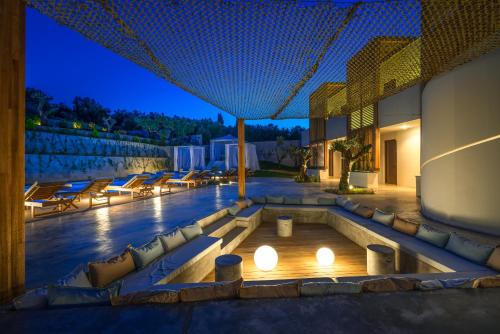 a villa with a swimming pool at night at Zante Maris Suites - Adults Only in Tsilivi