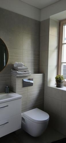 a bathroom with a white toilet and a sink at Villa by the Baltic Sea in Palanga