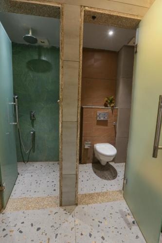 a bathroom with a toilet and a shower at Aceotel Select Aria, Bhopal -A Luxury Boutique Hotel in Bhopal