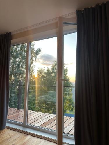 a sliding glass door with a view of a deck at Vista Krasiya in Vyshka