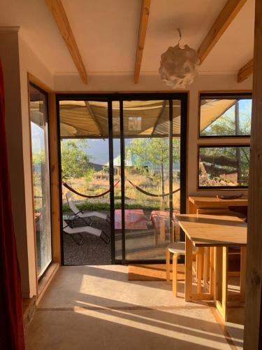 a room with a glass door with a view of a patio at Santuario Cosmico Mamalluca in Vicuña